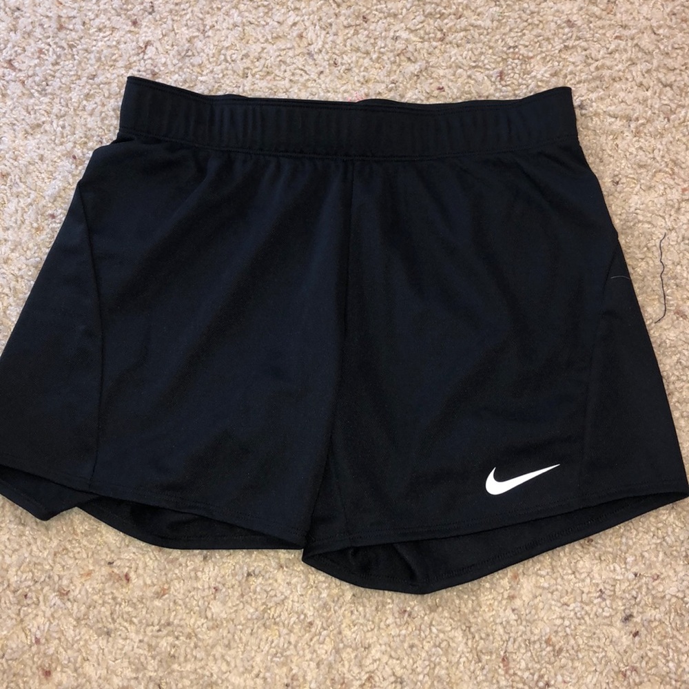 Black Nike athletic shorts.